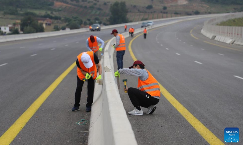Workers make final preparations for the traffic opening of the 84-km eastern section of the East-West Highway in El Tarf Province, Algeria, on July 1, 2023. A landmark Algerian highway built to connect 17 provinces has been completed with China's CITIC Construction delivering its final 84-km segment on Saturday. (CITIC Construction Algeria/Handout via Xinhua)