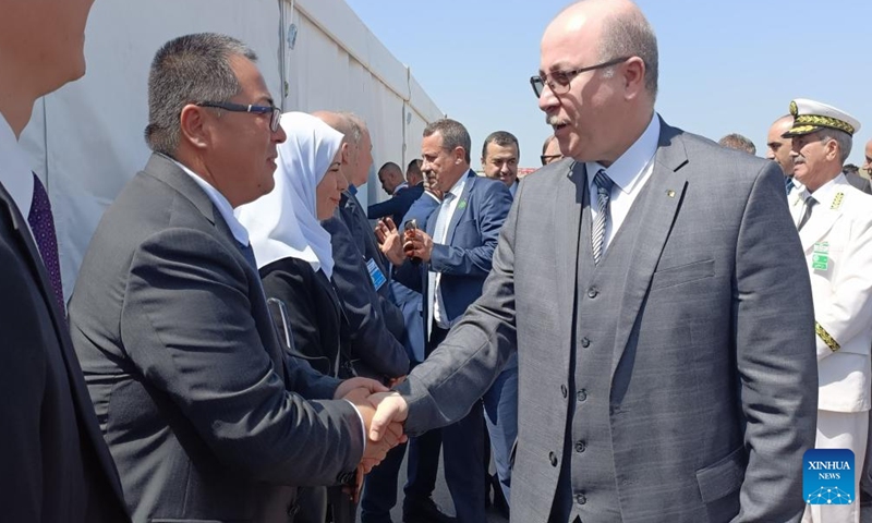 Algerian Prime Minister Ayman Benabderrahmane (R) shakes hands with Qi Shujie, deputy general manager of CITIC Construction Algeria, during the inauguration ceremony of the 84-km project of Algerian East-West Highway in El Tarf Province, Algeria, on Aug. 12, 2023. A landmark Algerian highway built to connect 17 provinces has been completed with China's CITIC Construction delivering its final 84-km segment on Saturday. (CITIC Construction Algeria/Handout via Xinhua)