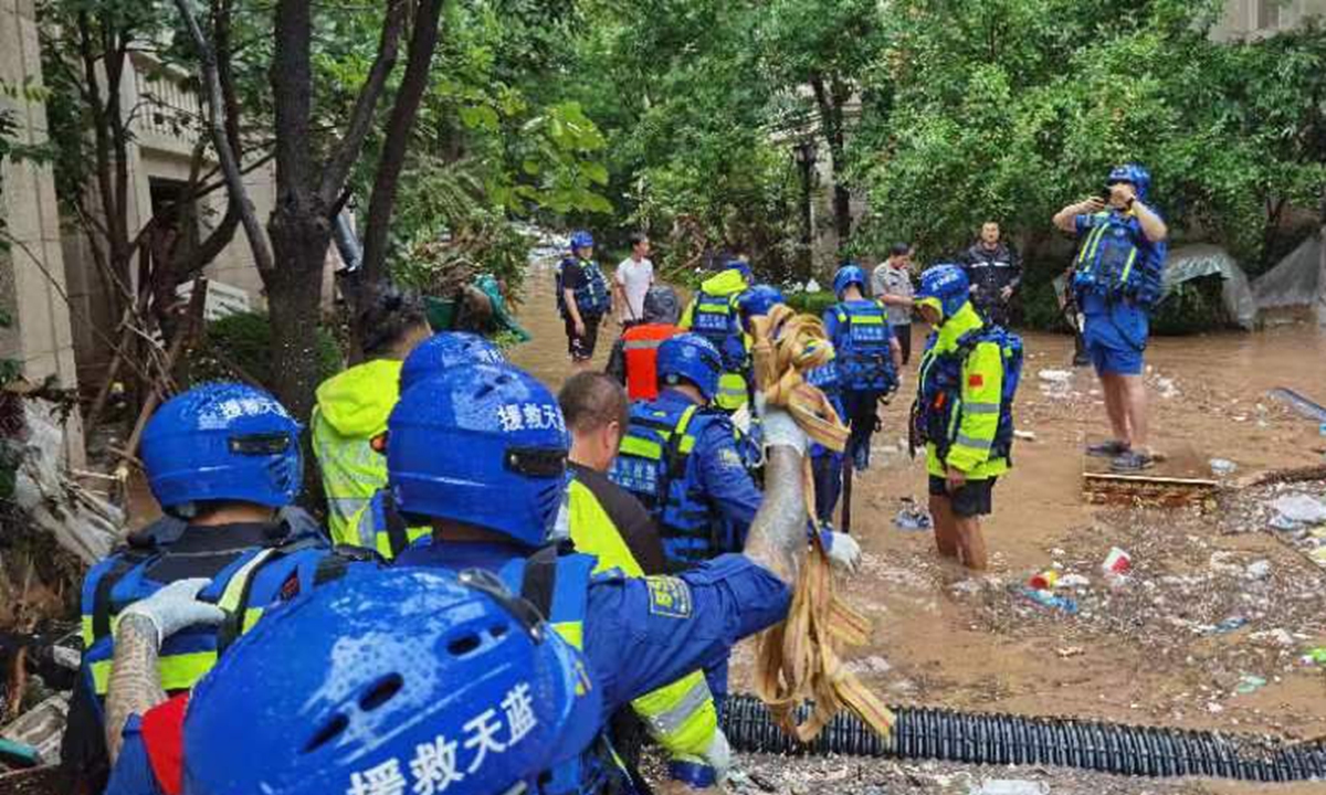 Members of the Beijing Blue Sky Rescue, a Chinese civil relief squad, carry out a rescue in Fangshan district, Beijing on July 31, 2023 in heavy rainfall. Photo: Courtesy of the Beijing Blue Sky Rescue