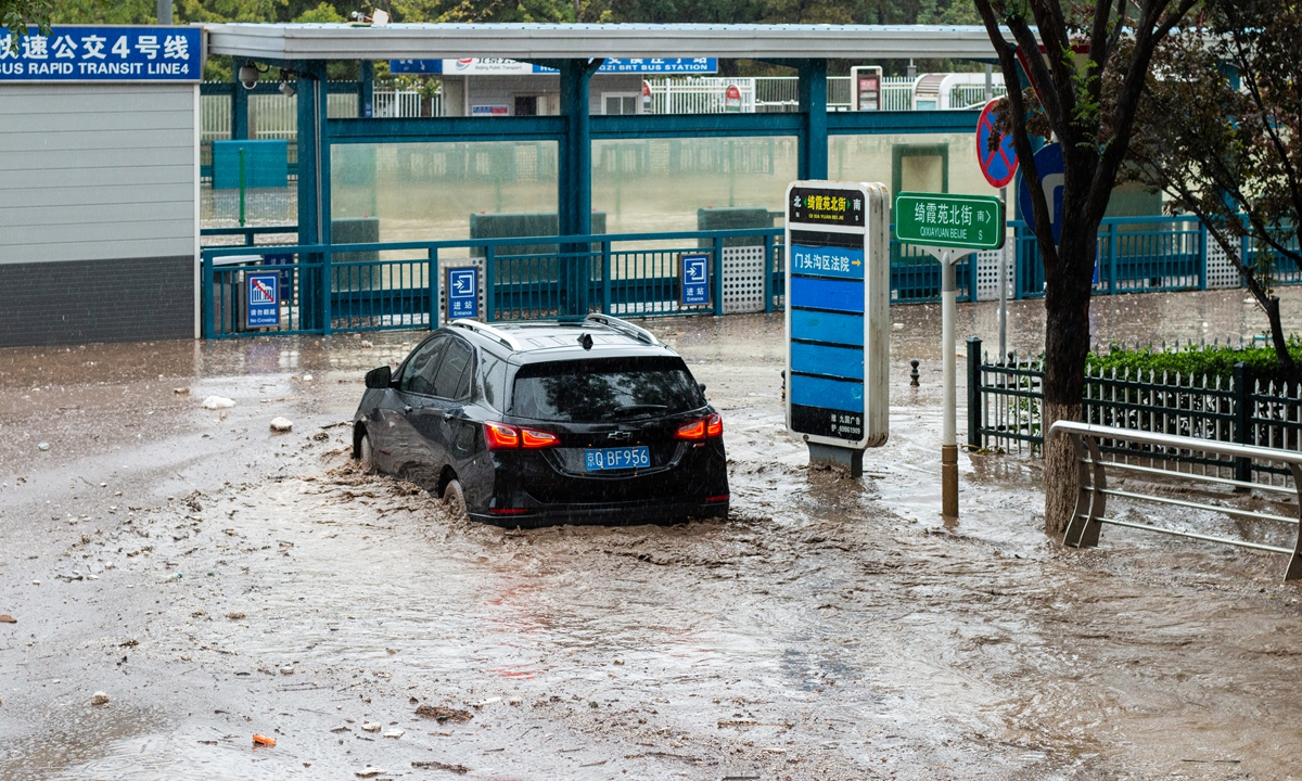 A car plows through a flooded street in Mentougou district, Beijing, on July 31, 2023. Photo: IC