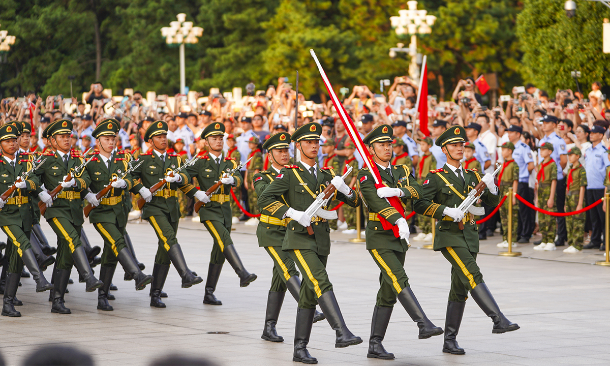 Soldiers escort the national flag for a flag-raising ceremony at Bayi Square in Nanchang, East China's Jiangxi Province, to celebrate the 96th anniversary of the August 1 Nanchang Uprising and the founding of the Chinese People's Liberation Army. Photo: VCG