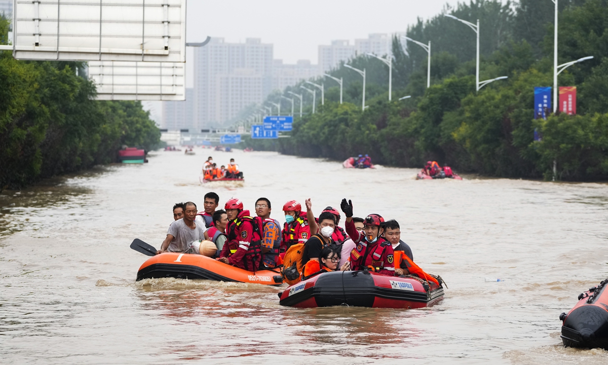 Residents evacuate on rubber boats through floodwaters in Zhuozhou in northern China's Hebei Province, south of Beijing on August 2, 2023. Rescue teams continued their work on Wednesday in Zhuozhou to extract people trapped in houses by floodwaters after days of downpours brought by Typhoon Doksuri.Photo:VCG