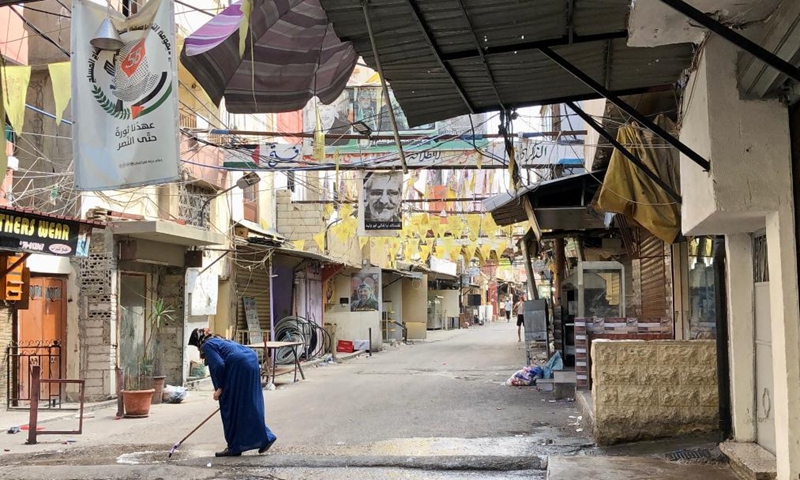 A Palestinian woman cleans a street in the Ain al-Helweh refugee camp near Sidon, southern Lebanon, on Aug. 1, 2023. Clashes erupted again on Tuesday in the refugee camp, hosting largely Palestinians, despite a cease-fire reached between rival factions late Monday.(Photo: Xinhua)