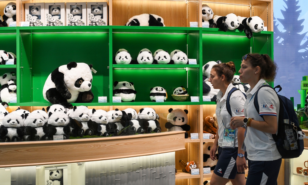 Foreign athletes browse the gift shop at the Chengdu Research Base of Giant Panda Breeding. Photo: Chen Tao/Global Times