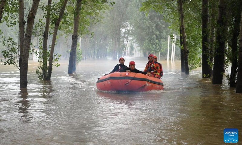 Rescuers head towards Shawo Village of Matou Town to carry out rescue operation in Zhuozhou, north China's Hebei Province, Aug. 3, 2023. Zhuozhou City is an area in Hebei that has been severely affected by rain-triggered floods. Local authorities set up 28 emergency rescue teams with a total of 8,755 people to help with the rescue and relief efforts. They worked in collaboration with soldiers stationed there and professional rescue teams.(Photo: Xinhua)