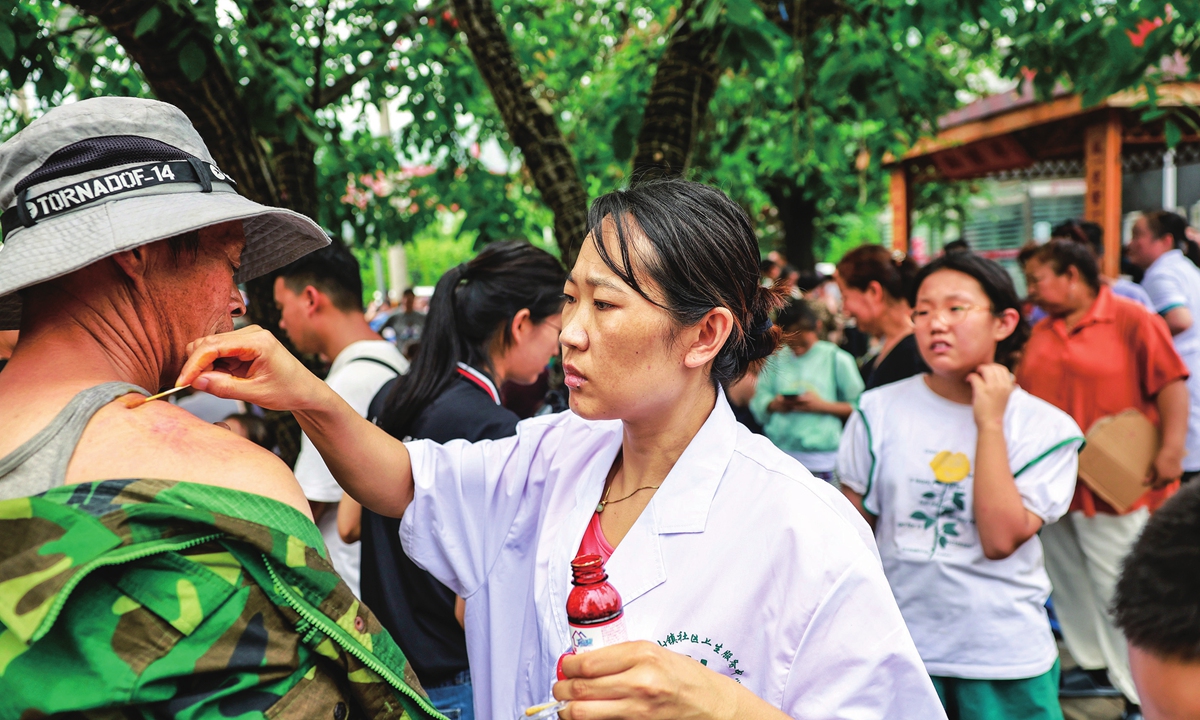 Medics treat injured residents at a temporary medical aid station set up for flood-hit residents in the Mentougou district, Beijing, on August 2, 2023. Photo: Li Hao/GT