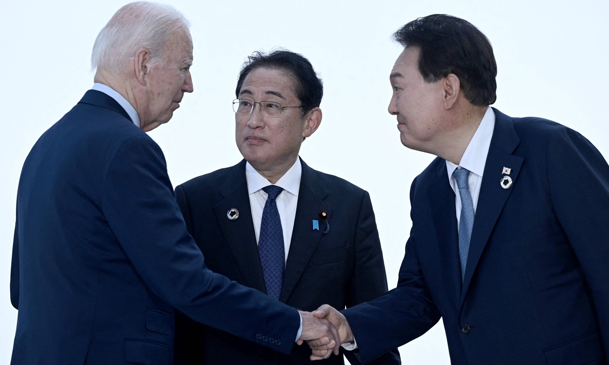 US President Joe Biden(from left to right), Japan's Prime Minister Kishida Fumio and South Korea's President Yoon Suk Yeol greet each other ahead of a trilateral meeting during the G7 Leaders' Summit in Hiroshima on May 21, 2023. Biden will host Fumio and Yoon for a summit at Camp David in Maryland on August 18, the White House said July 28, 2023. Photo: VCG  