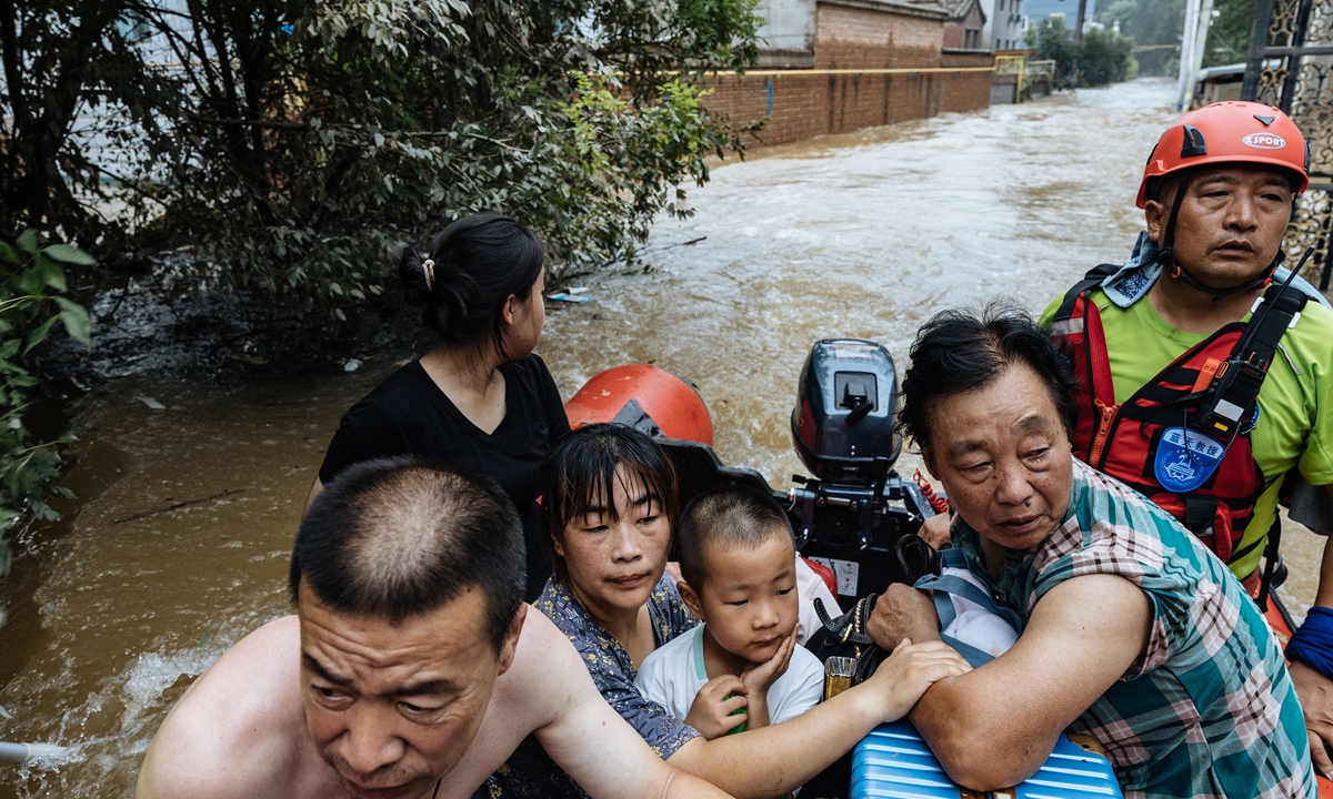 Residents are evacuated from a village by a volunteer rescue team, in Mengjiajie village, Zhuozhou city, North China's Hebei Province, on August 3, 2023. Photo: Li Hao/GT