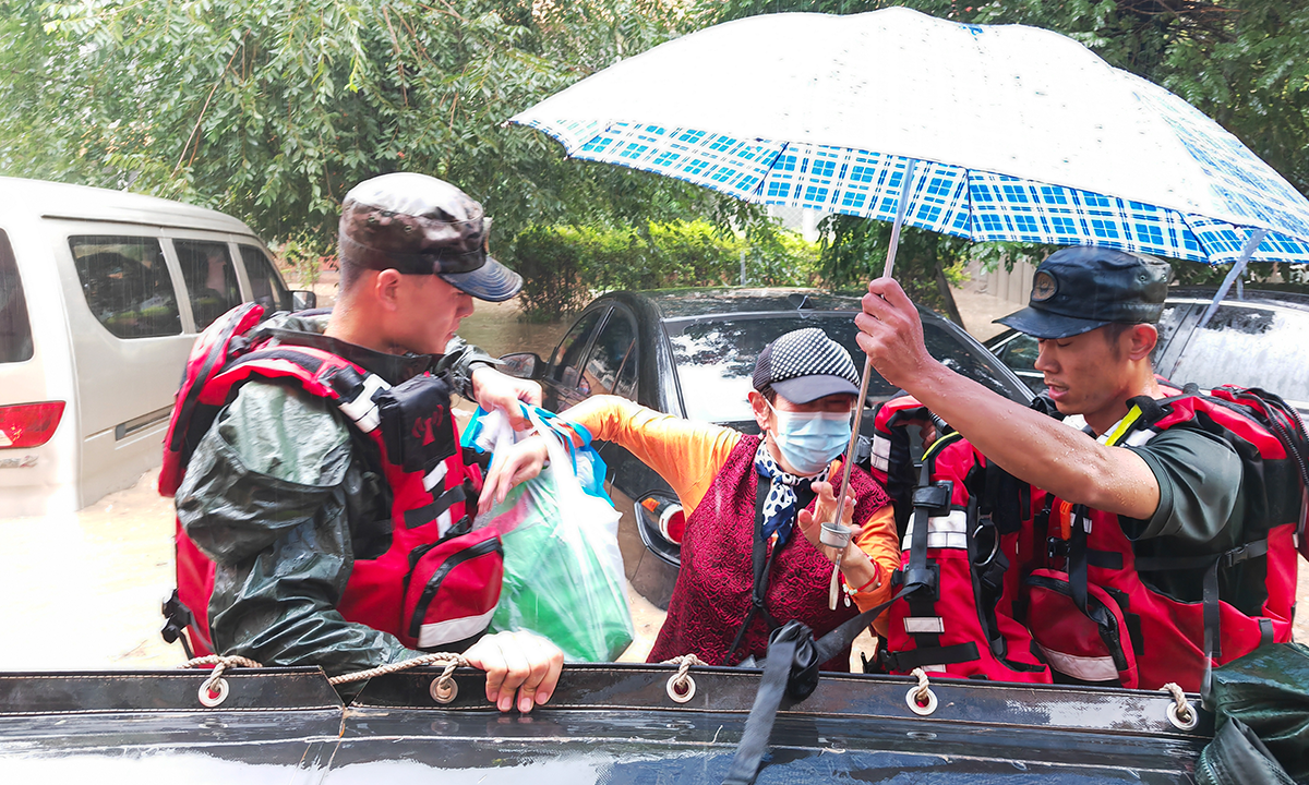 Soldiers from PLA Armed Police Force help transfer seniors from Songhe Elderly Care Home on August 2, 2023 in Liulihe town, Fangshan district in Beijing. Photo: Courtesy of First Mobile Contingent of the PLA Armed Police Force