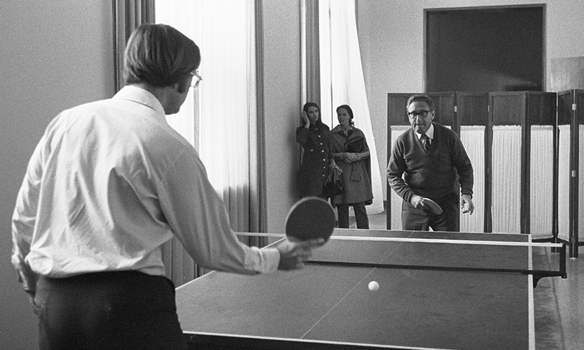 Winston Lord (in white shirt) faces Henry Kissinger as they try their hand at table tennis on their second trip to China, in October 1971. Photo: VCG