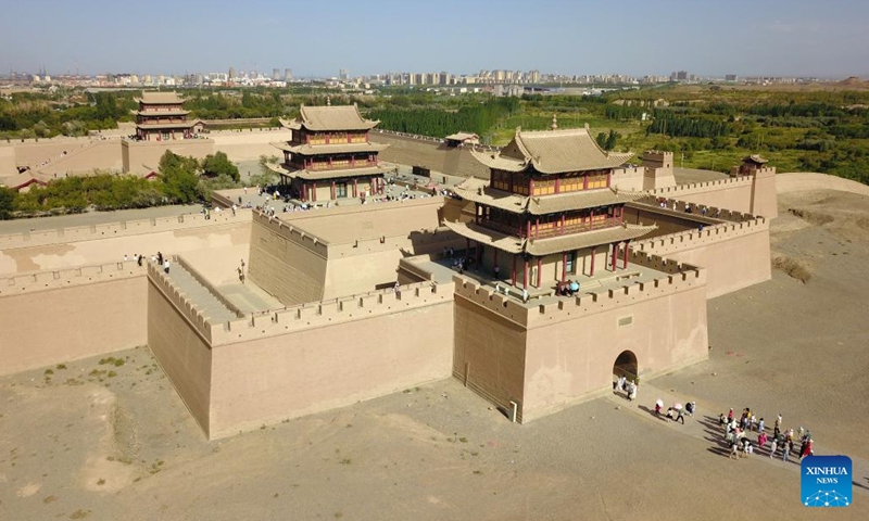 This aerial photo taken on Aug. 7, 2023 shows the Jiayu Pass in Jiayuguan City, northwest China's Gansu Province. The Jiayu Pass, a famed part of the Great Wall built in the Ming Dynasty (1368-1644), has attracted an increasing number of visitors during the summer tourist season with over 30,000 visitors daily at peak.(Photo: Xinhua)