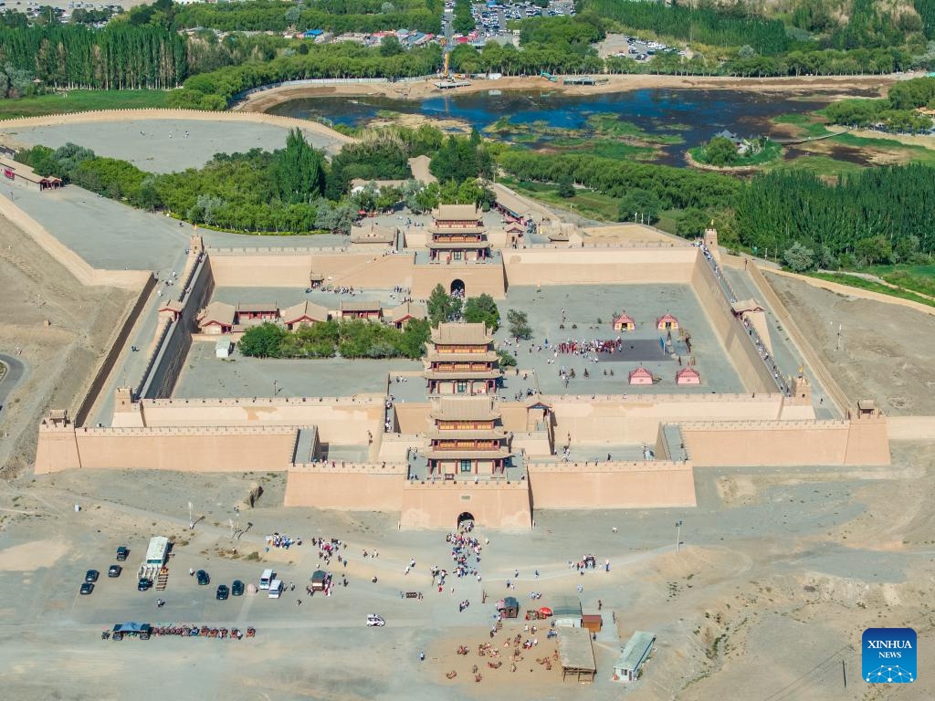 This aerial photo taken on Aug. 7, 2023 shows the Jiayu Pass in Jiayuguan City, northwest China's Gansu Province. The Jiayu Pass, a famed part of the Great Wall built in the Ming Dynasty (1368-1644), has attracted an increasing number of visitors during the summer tourist season with over 30,000 visitors daily at peak.(Photo: Xinhua)