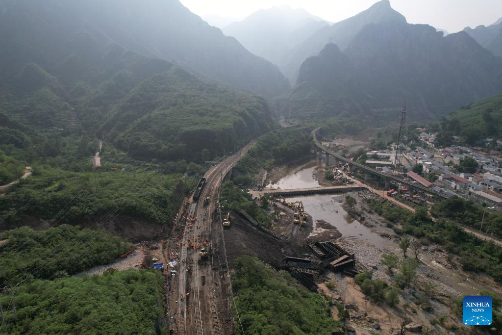 This aerial photo shows staff members repairing a flood-damaged section of Fengtai-Shacheng Railway in Beijing, capital of China, on Aug. 8, 2023. A track-confirming engine safely passed Zhuwo Station along Fengtai-Shacheng Railway on Tuesday evening, which marked the complete restoration of this flood-damaged railway after 71 hours of emergency repairing. The railway line connects Fengtai of Beijing and Shacheng Township of Zhangjiakou City in north China's Hebei Province.(Photo: Xinhua)