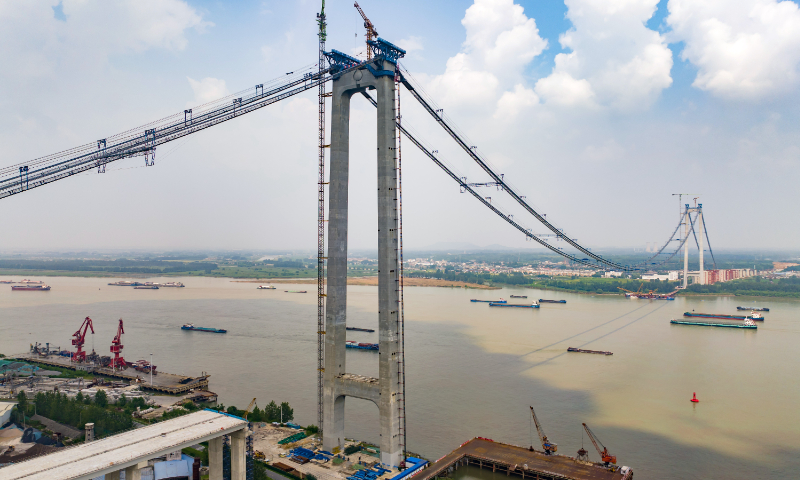 The main tower cable is being set up for the Longtan Yangtze River Bridge in Nanjing, East China's Jiangsu Province, on August 16, 2023. The bridge is a cross-river six-lane highway bridge, with a total length of 4.92 kilometers. It is expected to open to traffic by the end of 2024. Photo: VCG