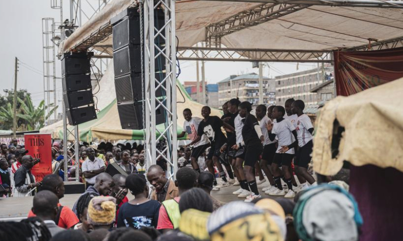 People watch performances during a carnival in Mathare slum of Nairobi, Kenya, Aug. 11, 2023. A slum carnival, organized by non-governmental organization Dream Building Service Association (DBSA), kicked off in the Mathare slum of Nairobi on Friday. Featuring art exhibitions, football matches and other activities, this carnival attracted numerous local residents. (Xinhua/Wang Guansen)