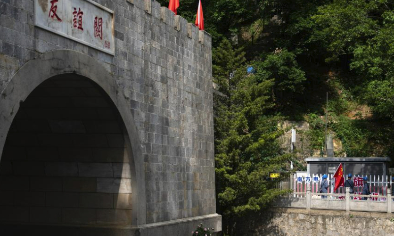 Maintenance personnel check power supply equipment near the Friendship Pass in Pingxiang, south China's Guangxi Zhuang Autonomous Region, Aug. 10, 2023. Wen Xianwen, Yao Zhengqiang, Deng Yiqiang and Li Yingxing are members of a team of maintenance personnel from the Guangxi branch of China Southern Power Grid's Pingxiang power supply station. Workers of the team, which was founded in 1974, have patrolled nearly 250,000-kilometer-long power transmission lines over the past 49 years. Led by Wen at present, the team has entered its fourth generation.