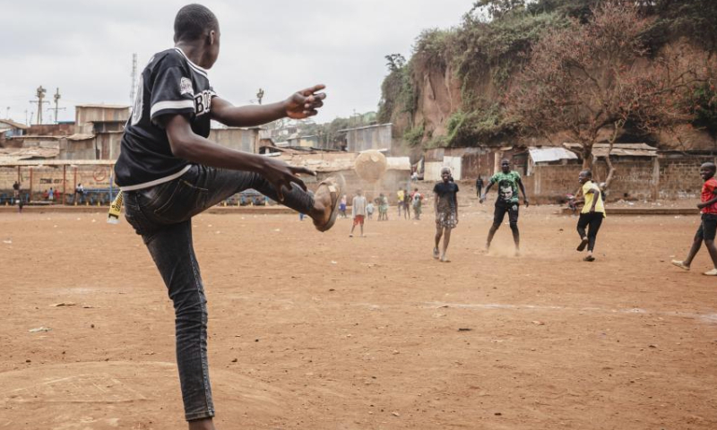 Children play football during a carnival in Mathare slum of Nairobi, Kenya, Aug. 11, 2023. A slum carnival, organized by non-governmental organization Dream Building Service Association (DBSA), kicked off in the Mathare slum of Nairobi on Friday. Featuring art exhibitions, football matches and other activities, this carnival attracted numerous local residents. (Xinhua/Wang Guansen)