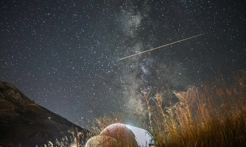 A Perseid meteor shower is pictured over Turkish resort city of Antalya on Aug. 12, 2023. (Mustafa Kaya/Handout via Xinhua)