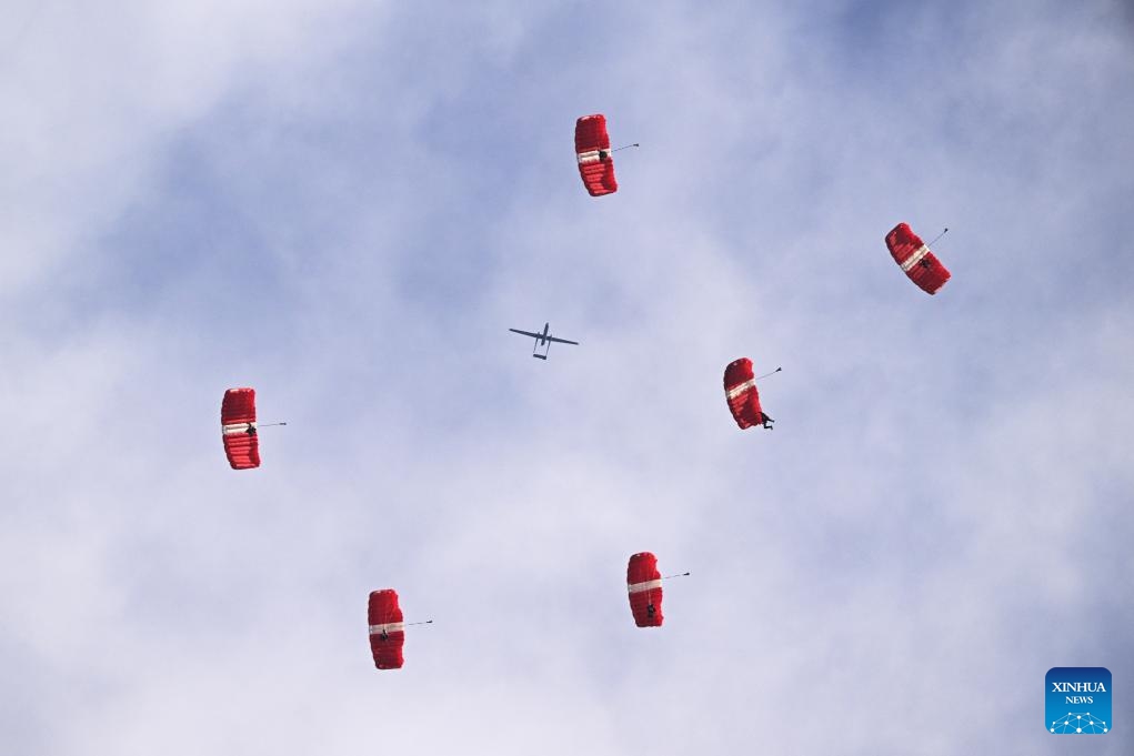 Skydivers of Red Lions team perform during the National Day Parade at Singapore's Padang on Aug. 9, 2023. Singapore held a National Day Parade on Wednesday to celebrate its 58th anniversary at Padang, an open playing field near the iconic Marina Bay, with a military show, performances and fireworks.(Photo: Xinhua)
