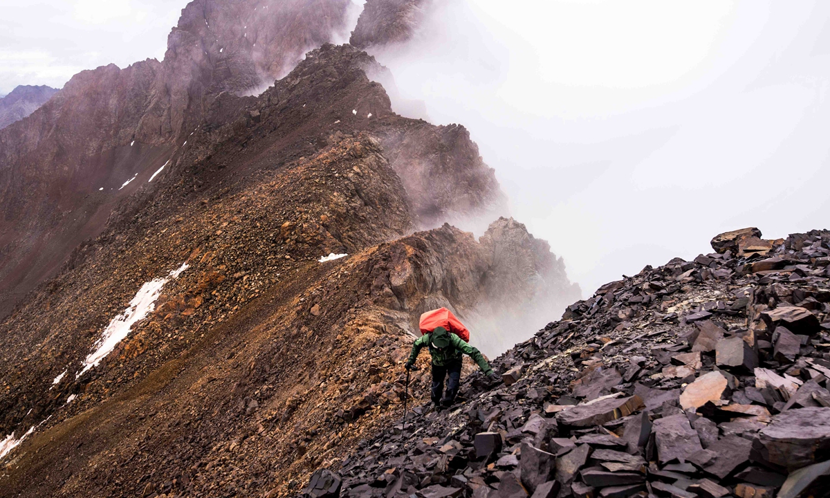 A hiker climbs a mountain. Photo: Kyle Obermann 