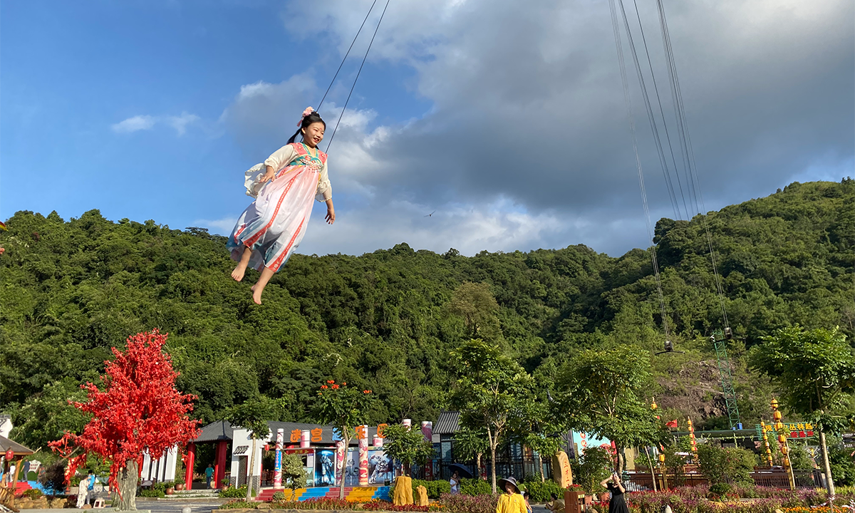 A visitor attached to a harness flies through the air at Guanyin Mountain National Forest Park on July 22, 2023. Photo: Shan Jie/Global Times
