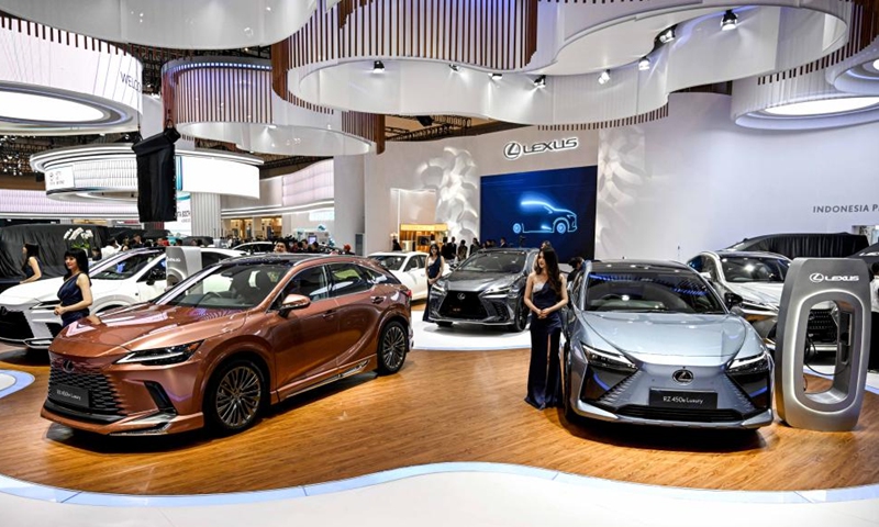 Models stand beside vehicles displayed at the GAIKINDO Indonesia International Auto Show (GIIAS) 2023 in Tangerang of Banten province, Indonesia, Aug. 10, 2023. The GIIAS 2023 opened here Thursday and will last till Aug. 20. (Photo: Xinhua)