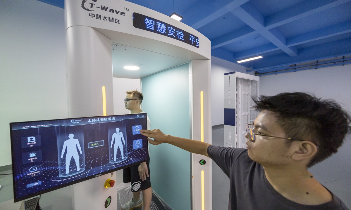 A technician scans a person through the company's self-developed terahertz body scanner on August 14, 2023 in Hefei, East China's Anhui Province. The Luyang Economic Development Zone in Hefei, where the company locates, aims to cultivate more specialized and sophisticated enterprises to produce new and unique products. Photo:cnsphoto