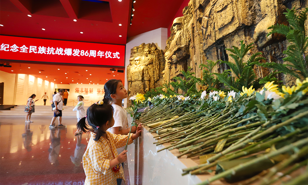 Children visit the Museum of the War of Chinese People's Resistance against Japanese Aggression and present flowers in honor of those who sacrificed their lives in the War of Resistance against Japanese Aggression, in Beijing, on July 7, 2023. Photo: VCG