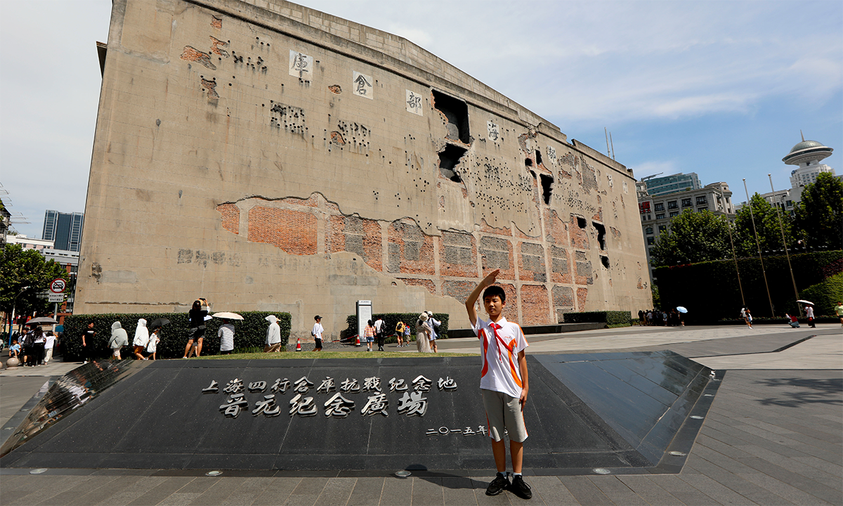 A Chinese teenager poses in front of the Sihang Warehouse Battle Memorial in Shanghai, on August 13, 2023. Photo: Chen Xia/GT