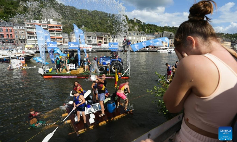 Participants interact with spectators during the International Bathtub Regatta on the Meuse River in Dinant, Belgium, on Aug. 15, 2023. Starting in 1982, participants vie to create the most impressive bathtub-based craft and compete down the Meuse River in Dinant on Aug. 15 each year.(Photo: Xinhua)