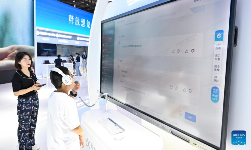 A boy experiences the AI-powered large language model dubbed Spark Desk, a generative language model launched by iFlytek, a leading Chinese AI company, at the venue for 2023 Smart China Expo in southwest China's Chongqing, Sept. 3, 2023. The 2023 Smart China Expo will be held at Chongqing International Expo Center from Sept. 4 to 6. (Xinhua/Wang Quanchao)