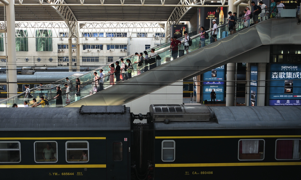 Passengers board the train at the Nanchang railway station in East China's Jiangxi Province on August 17, 2023. The summer travel peak has hit the national railway system with a total of 614 million passengers transported from July 1 to August 15. Photo: VCG