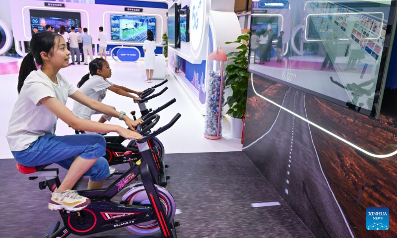 Children experience digital device at the venue for 2023 Smart China Expo in southwest China's Chongqing, Sept. 3, 2023. The 2023 Smart China Expo will be held at Chongqing International Expo Center from Sept. 4 to 6. (Xinhua/Wang Quanchao)