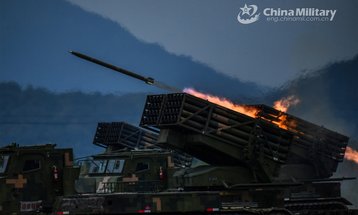 A vehicle-mounted multiple launch rocket system (MLRS) attached to an artillery element of an army brigade fires at mock target during a round-the-clock training exercise held in recent days. (eng.chinamil.com.cn/Photo by Liu Zhiyong)