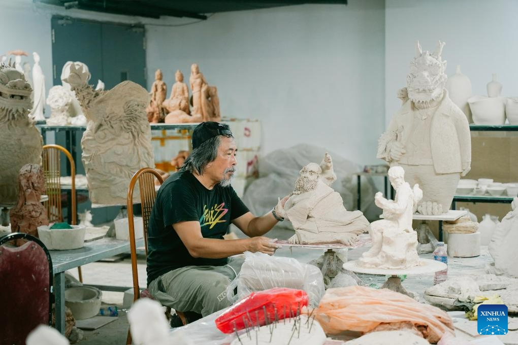 A pottery artist makes a product in Bat Trang Pottery Village, Gia Lam district, Hanoi, Vietnam on Aug. 19, 2023. Bat Trang has a long history of porcelain and pottery making. The village's ceramic and pottery products are well known for high quality and abundant styles.(Photo: Xinhua)