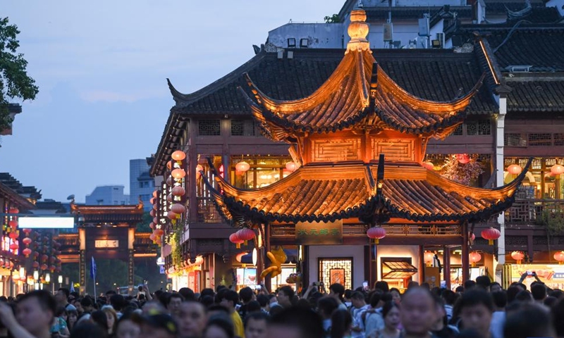 Tourists visit the Fuzi (Confucius) Temple scenic area in Nanjing, east China's Jiangsu Province, Aug. 18, 2023. Qinhuai District of Nanjing has been boosting and diversifying its tourism economy in recent years through joint efforts in entertainment, sightseeing, catering and shopping services. A number of tourist attractions designed for nighttime visit were established there to enrich the nightlife of both tourists and local residents, and infuse new vigor into urban consumption.(Photo: Xinhua)