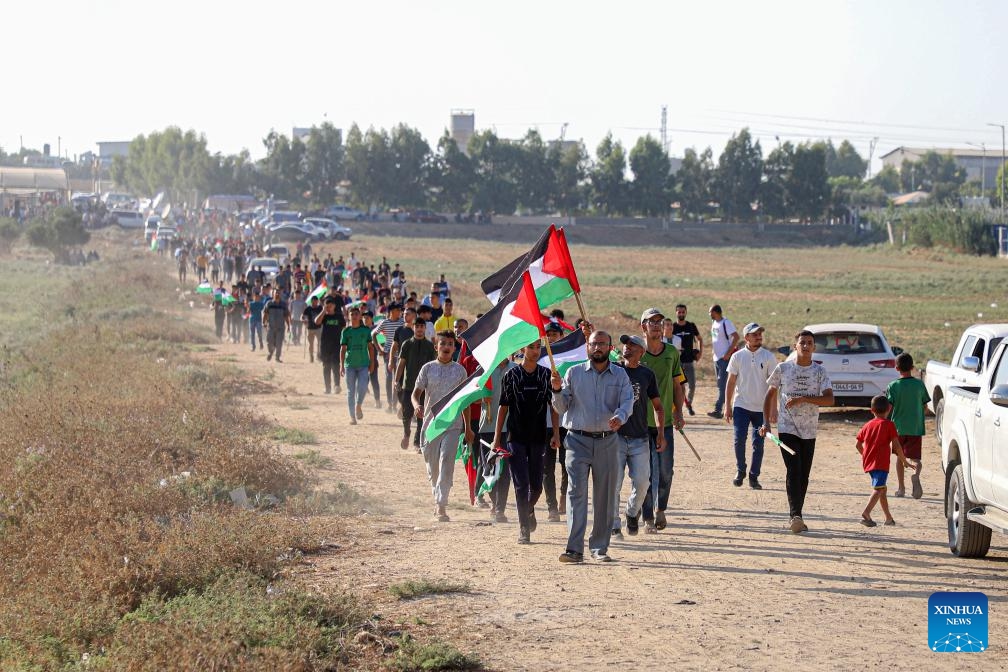Palestinians take part in a protest to mark the 54th anniversary of the burning of Al-Aqsa Mosque near the fence of the Gaza-Israel border, east of Gaza City, on Aug. 21, 2023. Dozens of Palestinians were injured on Monday during clashes with the Israeli soldiers at the Gaza border with Israel and the West Bank, Palestinian medics and eyewitnesses said.(Photo: Xinhua)
