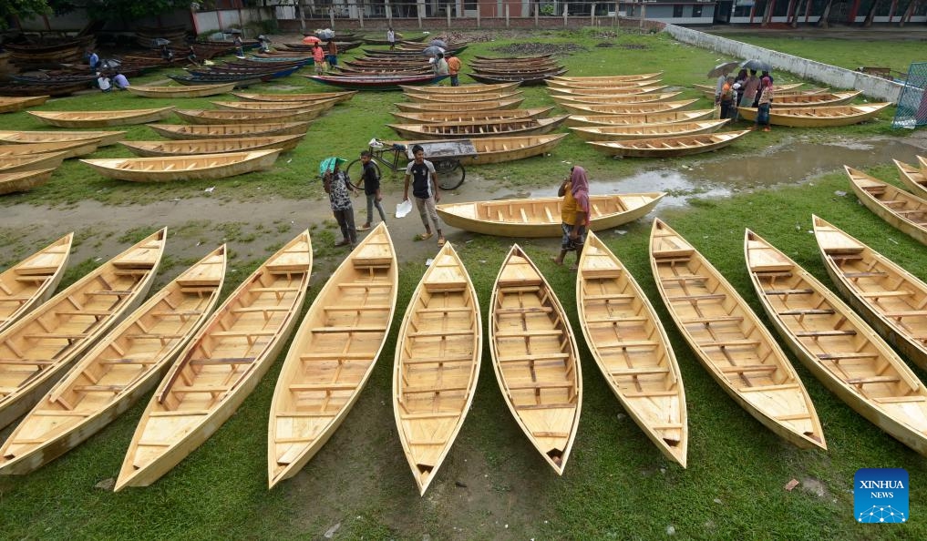 Hand-made wooden boats are displayed for sale at an open-air marketplace in Manikganj district, Bangladesh, Aug. 23, 2023. Sales of the traditional small boats usually increase at this time of the year. In this part of Bangladesh, water transportation is still an important means of communication during the monsoon season from June to September.(Photo: Xinhua)
