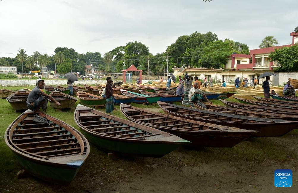 Hand-made wooden boats are displayed for sale at an open-air marketplace in Manikganj district, Bangladesh, Aug. 23, 2023. Sales of the traditional small boats usually increase at this time of the year. In this part of Bangladesh, water transportation is still an important means of communication during the monsoon season from June to September.(Photo: Xinhua)