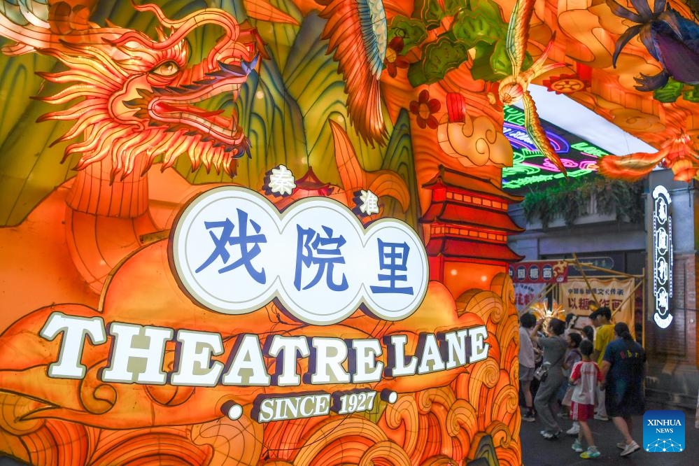 Tourists visit Theatre Lane scenic area in Nanjing, east China's Jiangsu Province, Aug. 21, 2023. Qinhuai District of Nanjing has been boosting and diversifying its tourism economy in recent years through joint efforts in entertainment, sightseeing, catering and shopping services. A number of tourist attractions designed for nighttime visit were established there to enrich the nightlife of both tourists and local residents, and infuse new vigor into urban consumption.(Photo: Xinhua)