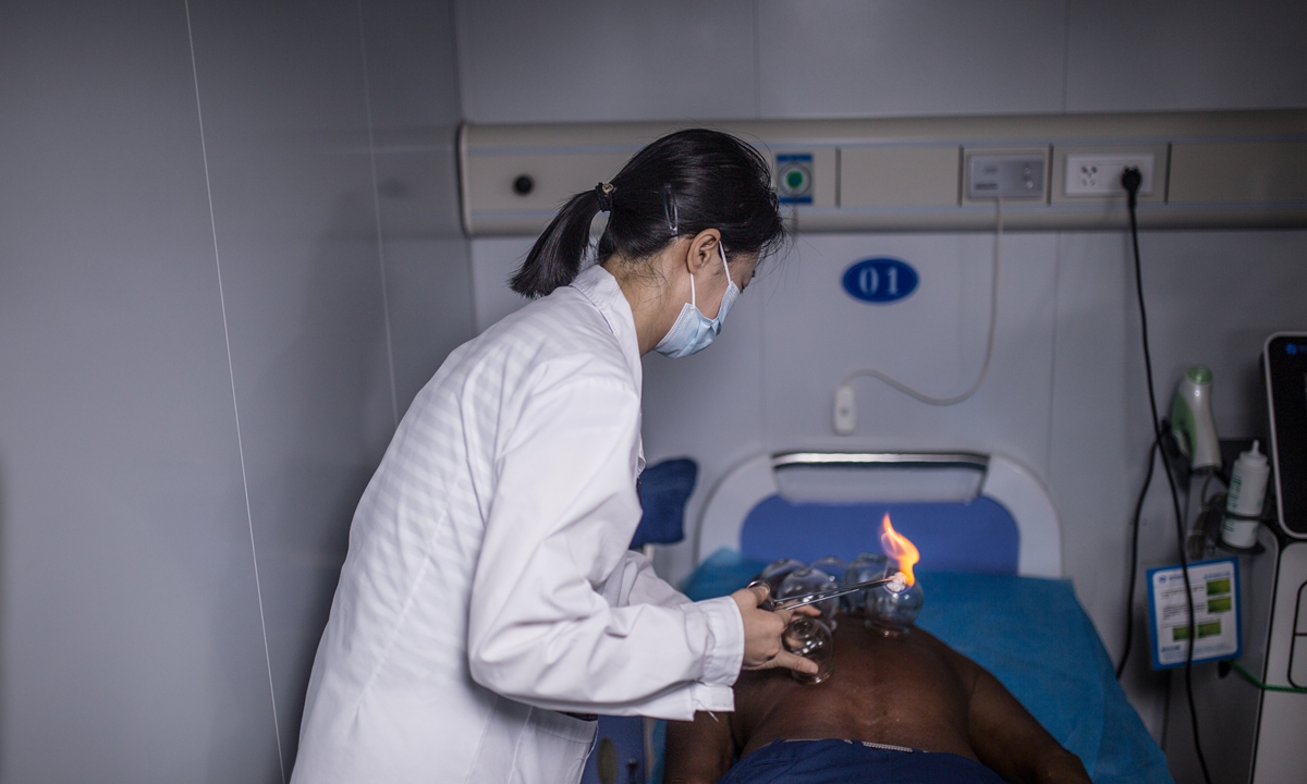 A Chinese doctor applies traditional cupping therapy to a local resident on the <em>Ark Peace</em> on August 21, 2023, in Honiara Photo: Shan Jie/GT
