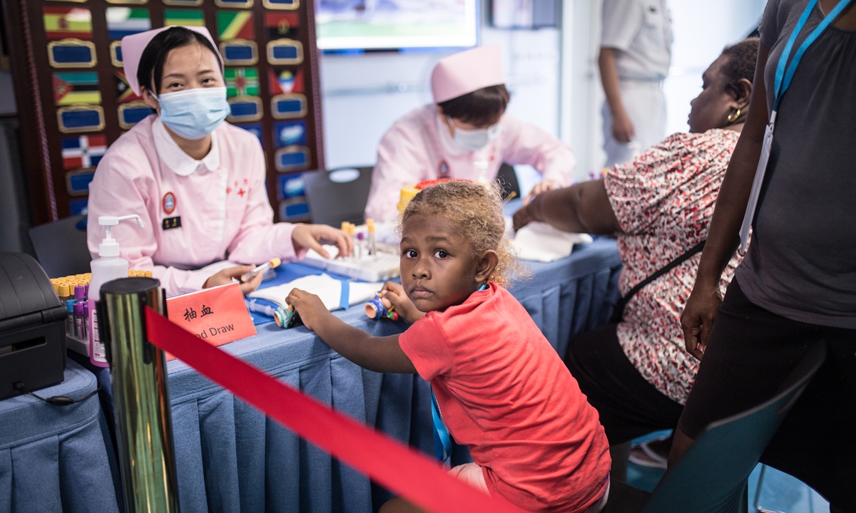 A child waits to be registered by a nurse on the <em>Ark Peace</em> on August 20, 2023 Photo: Shan Jie/GT