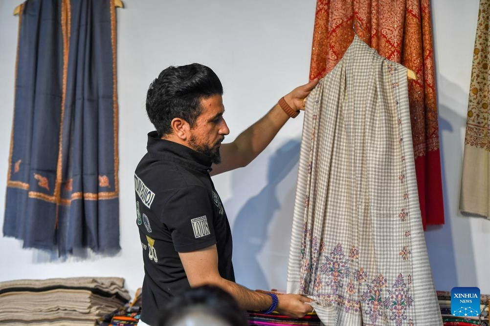 An Iranian exhibitor arranges exhibits at the 14th China-Northeast Asia Expo in Changchun, the capital city of northeast China's Jilin Province, Aug. 23, 2023. The 14th China-Northeast Asia Expo opened Wednesday in Changchun. The five-day event, scheduled both online and offline, has attracted more than 1,000 companies from home and abroad, with a predominant representation from countries in Northeast Asia.(Photo: Xinhua)