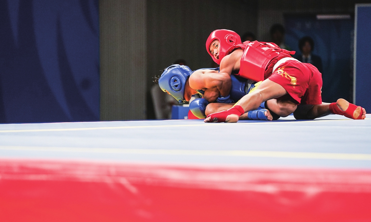 Ma Yigu (in red) competes at the men's Sanda 60 kg final in Chengdu Universiade. Photo: VCG