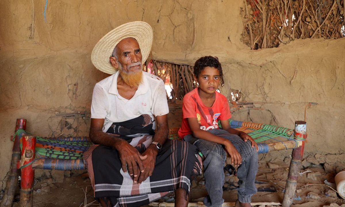 A man and his grandson sit inside their hut at a refugee camp in the Midi District of Hajjah Province, northern Yemen, on Aug. 16, 2023.(Photo by Mohammed Al-Wafi/Xinhua)





