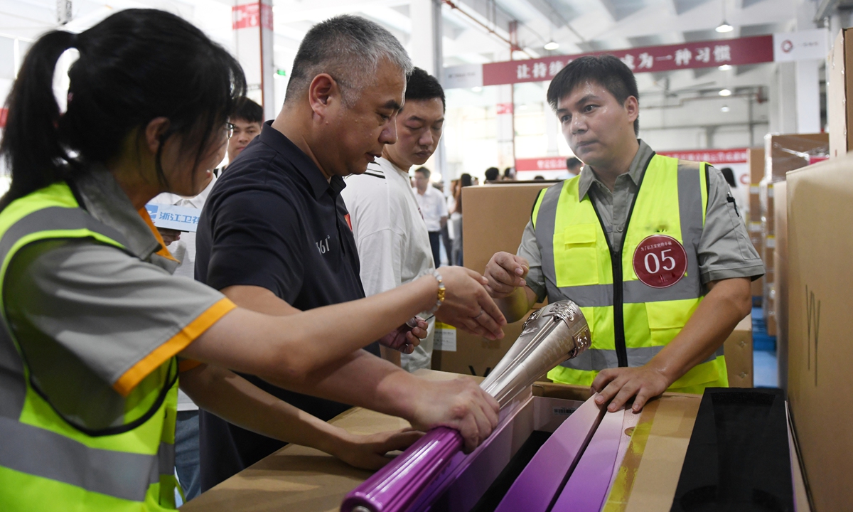 Staff members inspect the Asian Games torches in Ningbo, East China's Zhejiang Province, on September 4, 2023. The torch relay for the Hangzhou Asian Games will start on Friday and cover 11 cities in East China's Zhejiang Province until September 20. The opening ceremony will be held on September 23. Photo: VCG