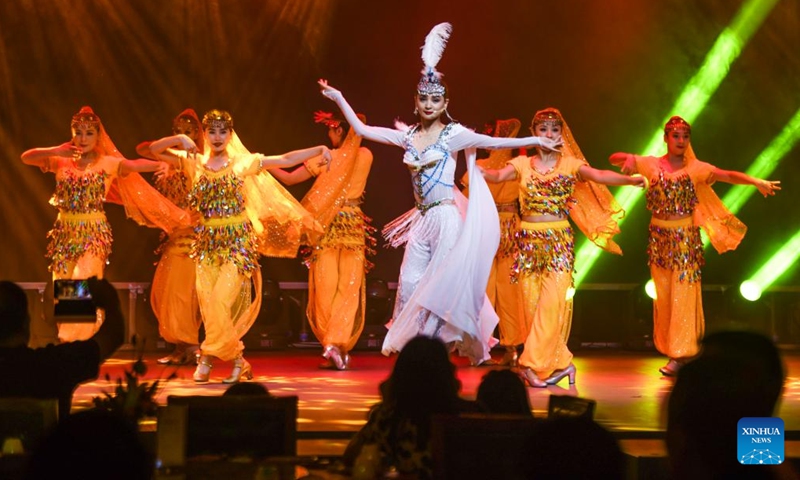 A performance is staged at the Xinjiang International Grand Bazaar in Urumqi, northwest China's Xinjiang Uygur Autonomous Region, Aug. 1, 2023. Xinjiang International Grand Bazaar, inaugurated in 2003, now serves as a key sightseeing and shopping destination, mainly selling local specialties such as dried fruits, medicinal herbs, carpets, jades, ethnic costumes and musical instruments.(Photo: Xinhua)