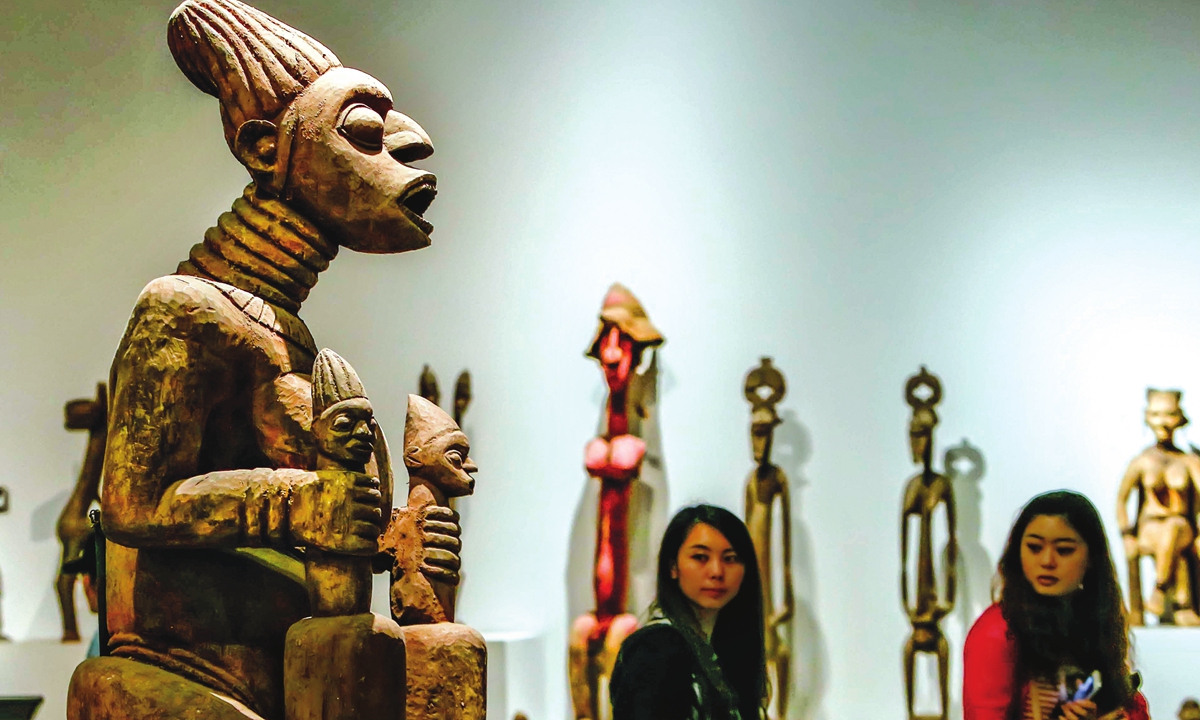 Chinese visitors admire an exhibition on African culture at the National Museum of China. Photo: cnsphoto