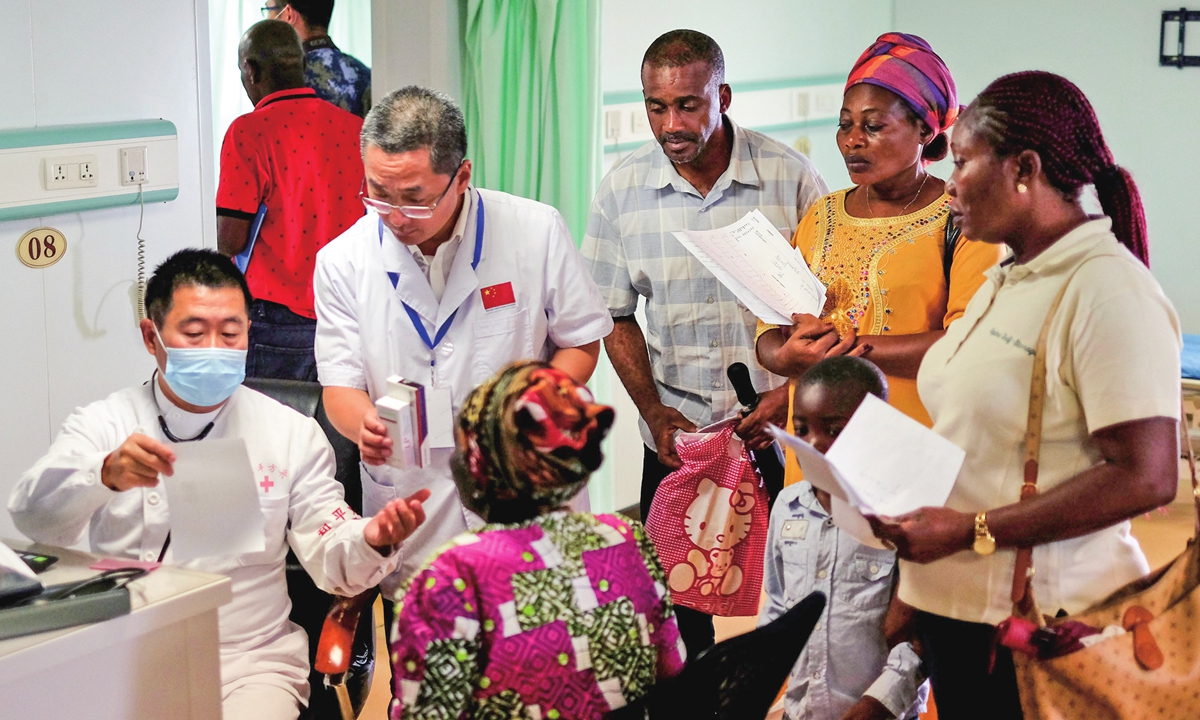 Doctors from the Peace Ark hospital ship answer questions from local patients when the ship visited Gabon in October 2017. Photo: cnsphoto