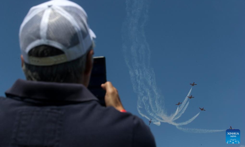 A spectator takes photos of the performance of Spanish aircraft during an air show at the Tanagra Air Base, some 70 kilometers north of Athens, Greece on Sept. 2, 2023. Athens Flying Week 2023 was held on Sept. 2 and Sept. 3 at the Tanagra Air Base. Photo: Xinhua